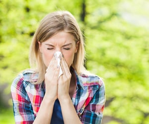 A woman sneezing
